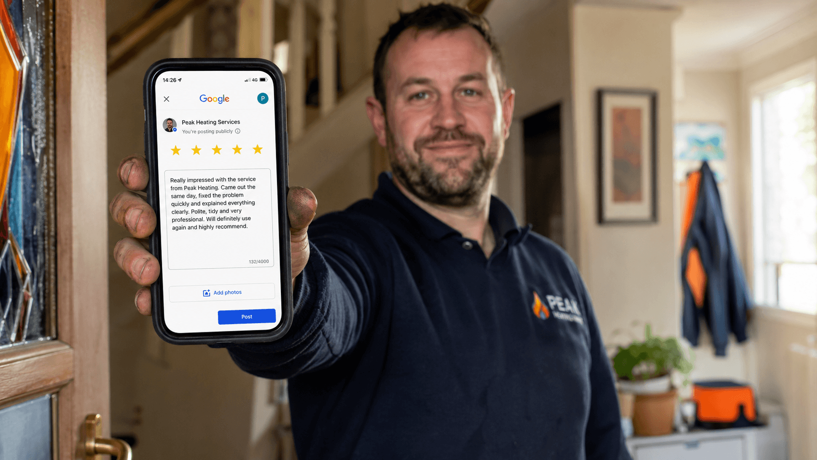 A heating engineer's hand holding a phone showing the Google review request screen at the end of a boiler service.